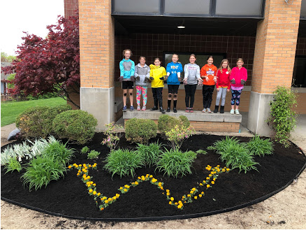 girls in front of a mulch bed